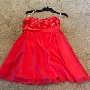 Orange strapless mini dress with sparkled criss cords design on bodice